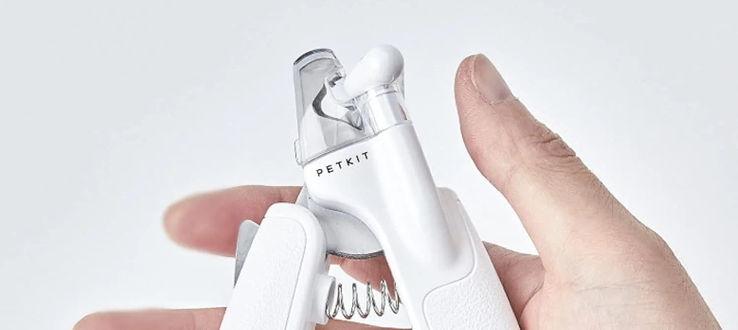 White pet nail clippers with built-in LED light and transparent anti-splash guard.