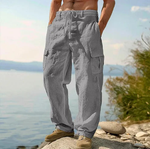 Man wearing loose light army green cotton wide-leg casual trousers with a micro-elastic mid-waist.
