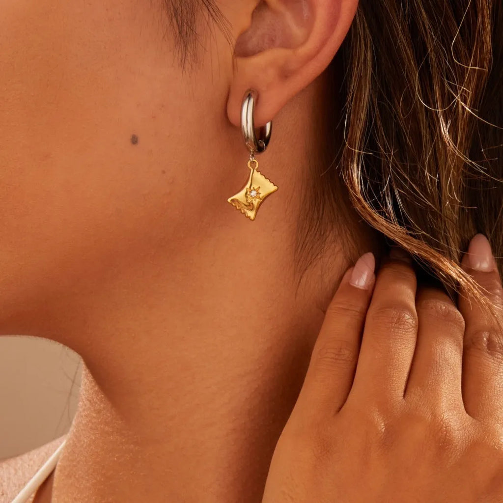 Pair of 18K gold plated stainless steel earrings featuring a Christmas tree design shaped into a heart.