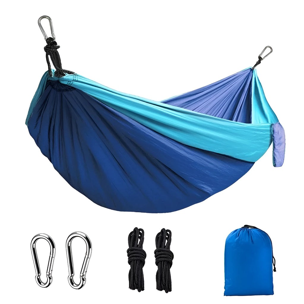 Blue nylon camping hammock hanging between trees with parachute fabric construction