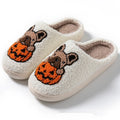 Black and white Halloween slippers with pumpkin design featuring plush uppers and non-slip rubber soles.