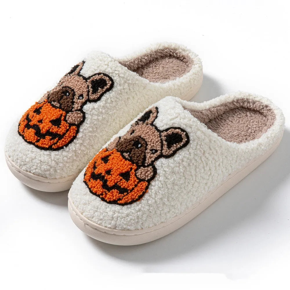 Black and white Halloween slippers with pumpkin design featuring plush uppers and non-slip rubber soles.