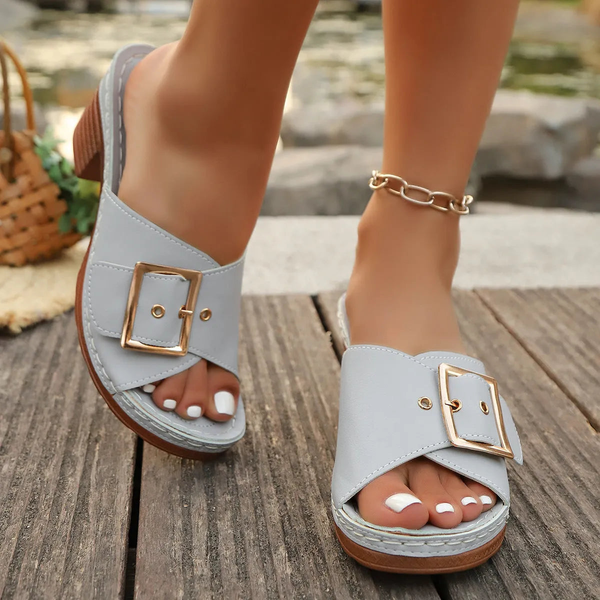 Women's black summer slippers with a chunky heel, round toe, and a silver metal buckle fastening.