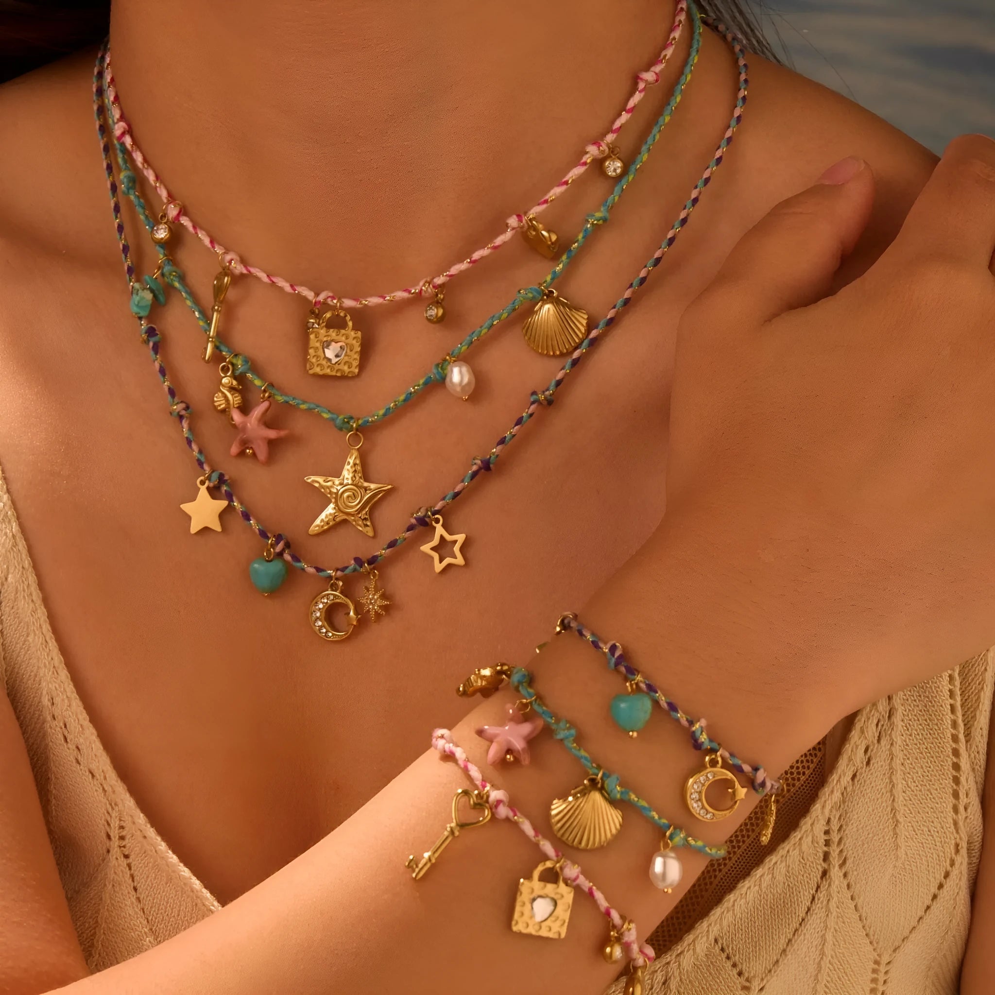 Braided rope chain stainless steel necklace with heart pendant and 18K gold plating on a model.