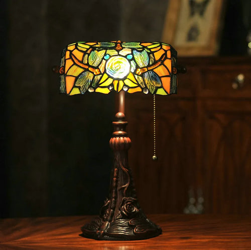 Tiffany style table lamp with coloured stained glass shade on a resin base.