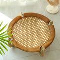 Brown woven rattan square pet bed basket for cats and small dogs on a wooden floor.