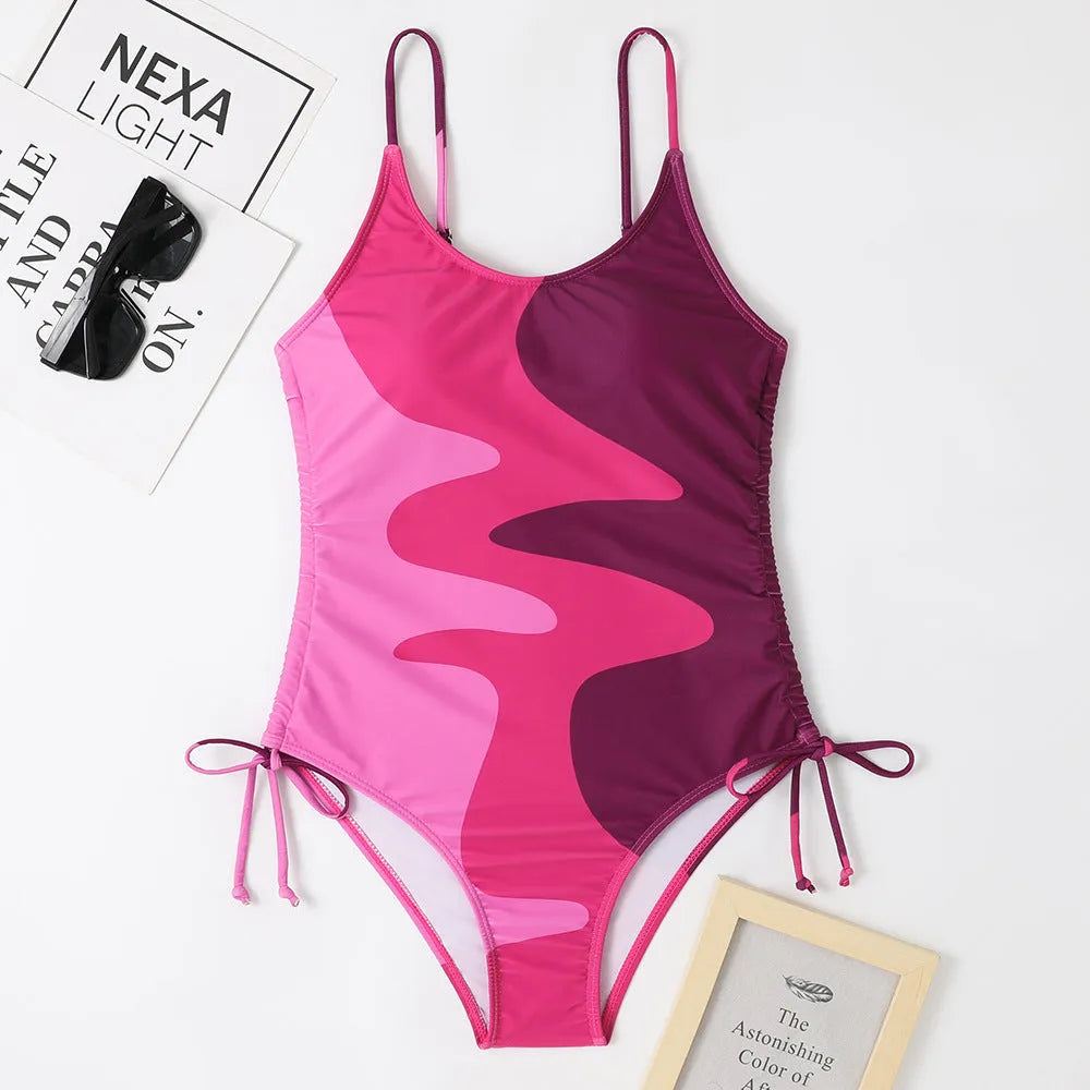 Women's blue sleeveless backless one-piece swimsuit on hanger