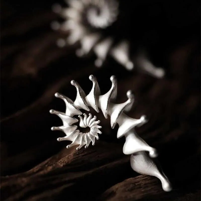 Conch coloured stud earrings with three-dimensional irregular design and matte alloy finish