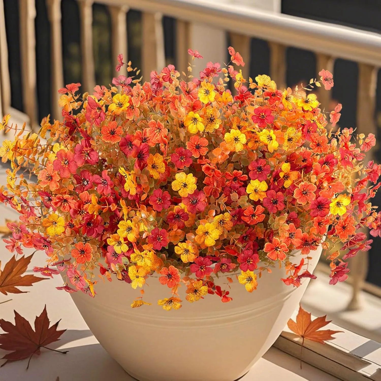 Artificial flower bouquet in autumn orange, yellow, and red colours with detailed plastic and silk construction