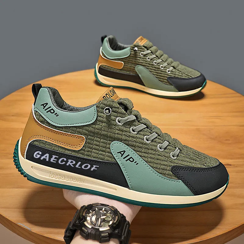 Men's grey mesh running shoes with round toe and lace-up closure on sports surface
