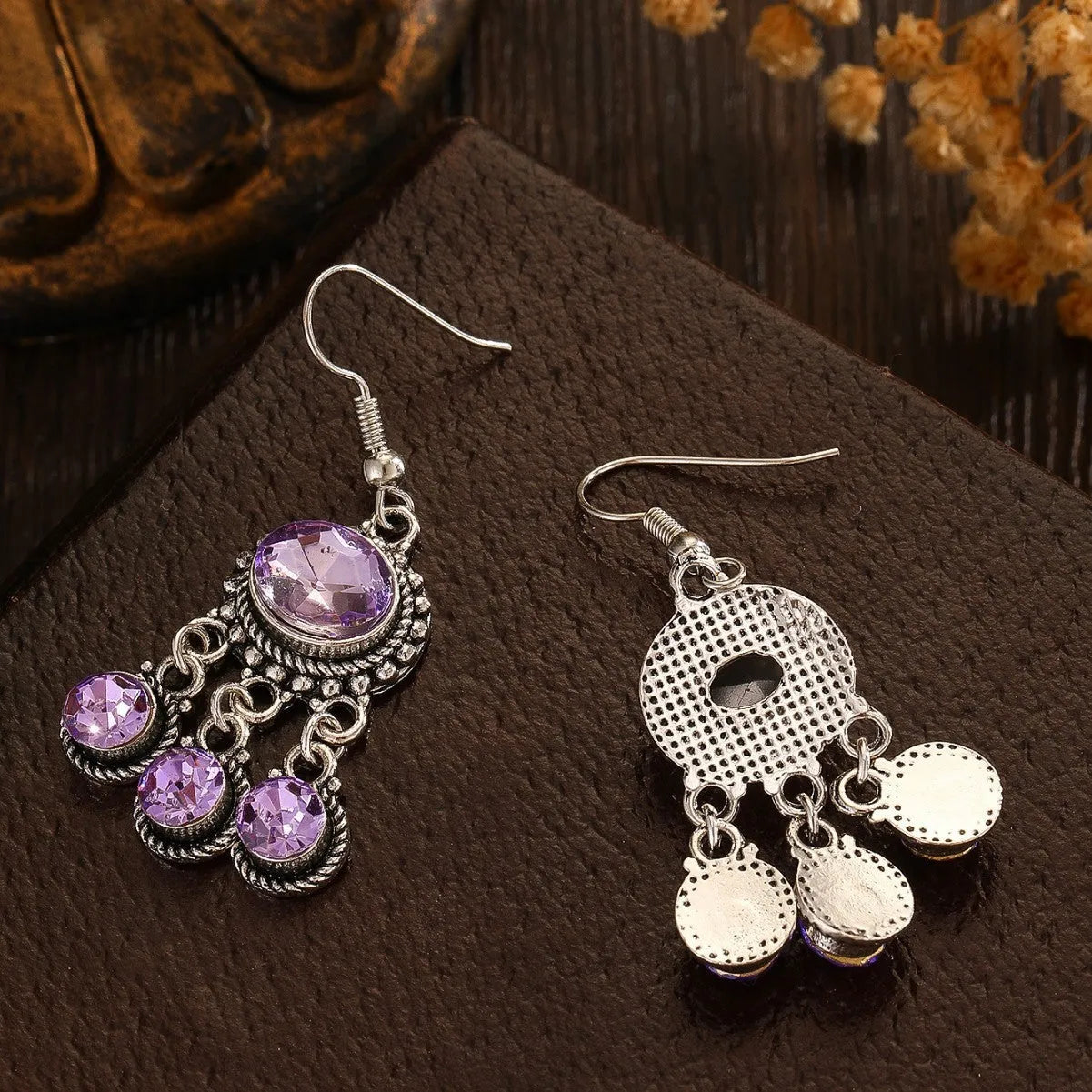 Long tassel alloy earrings in Dark Violet colour with hook fitting, hanging against a light background