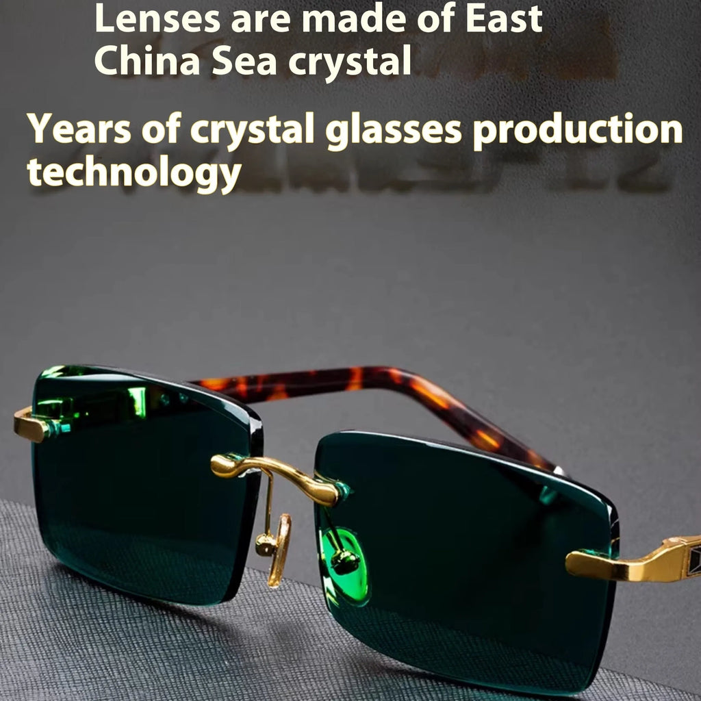 Frameless dark green crystal sunglasses shown with a glasses case and a lens cloth.