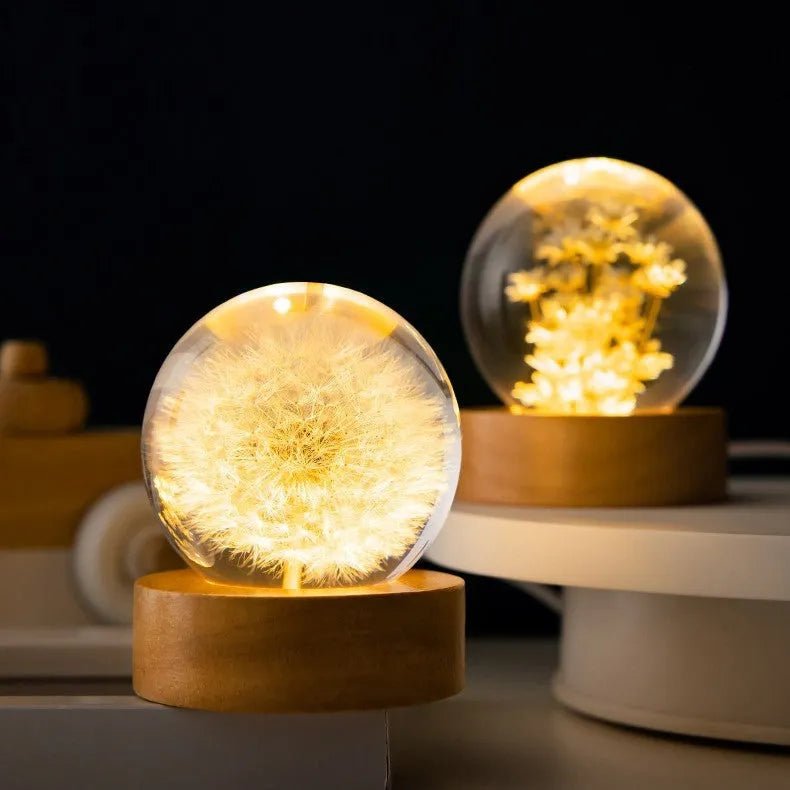 Dandelion crystal ball night light with wooden base, showing preserved flowers inside a 6cm resin sphere.