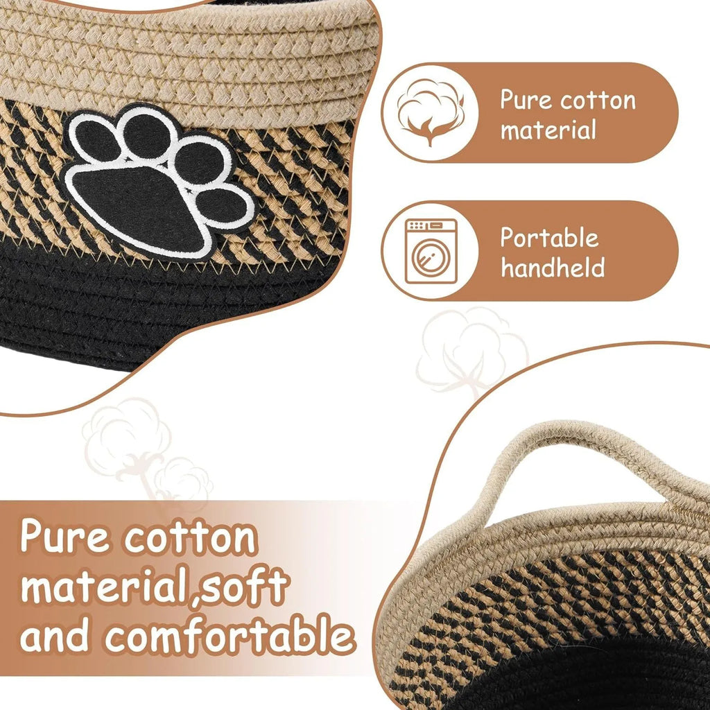 Handmade light beige woven cotton rope storage basket with a handle, shown on a wooden surface.