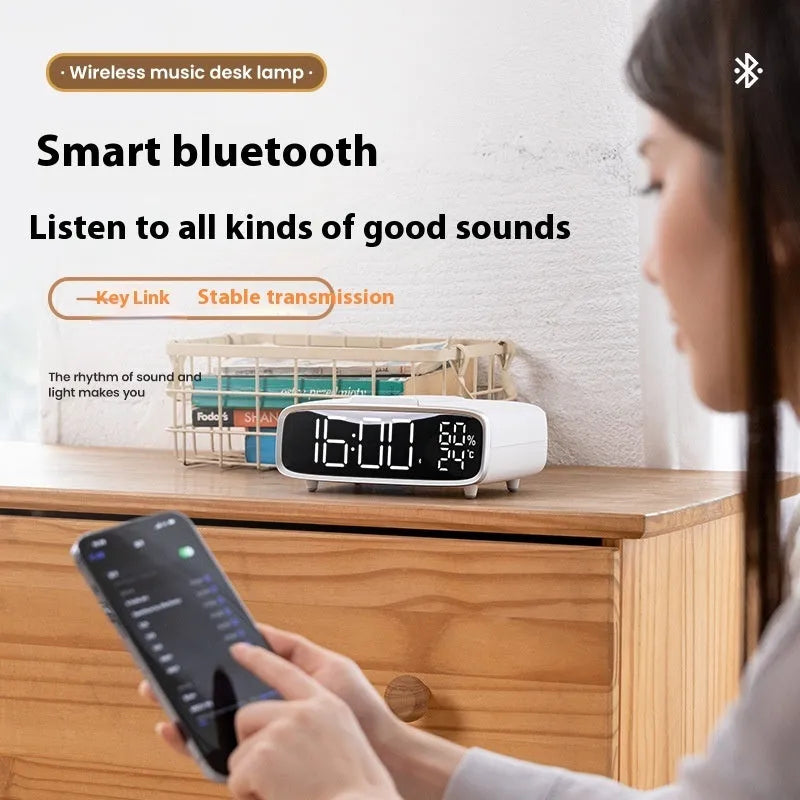 White ABS acrylic Bluetooth speaker with wireless charging pad and integrated night lamp