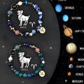 Two natural stone beaded bracelets with zodiac charms on a table, showing adjustable clasps.