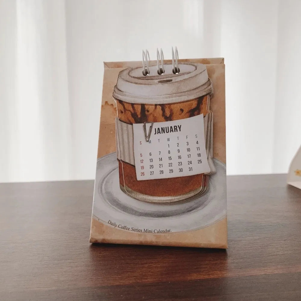 Mini 2025 desk calendar with simple modern design on a desk.