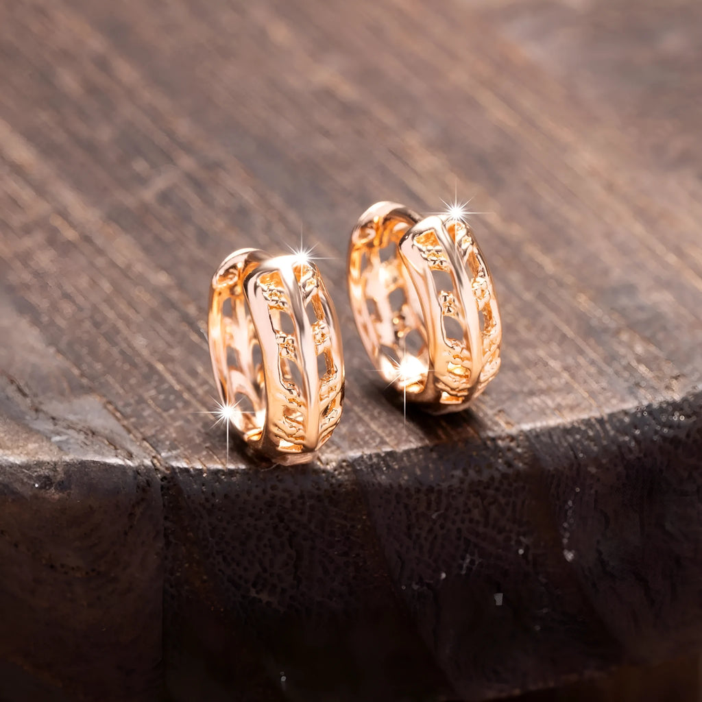 Hollowed-out copper earrings in heart and leaf shapes with a rose gold finish.