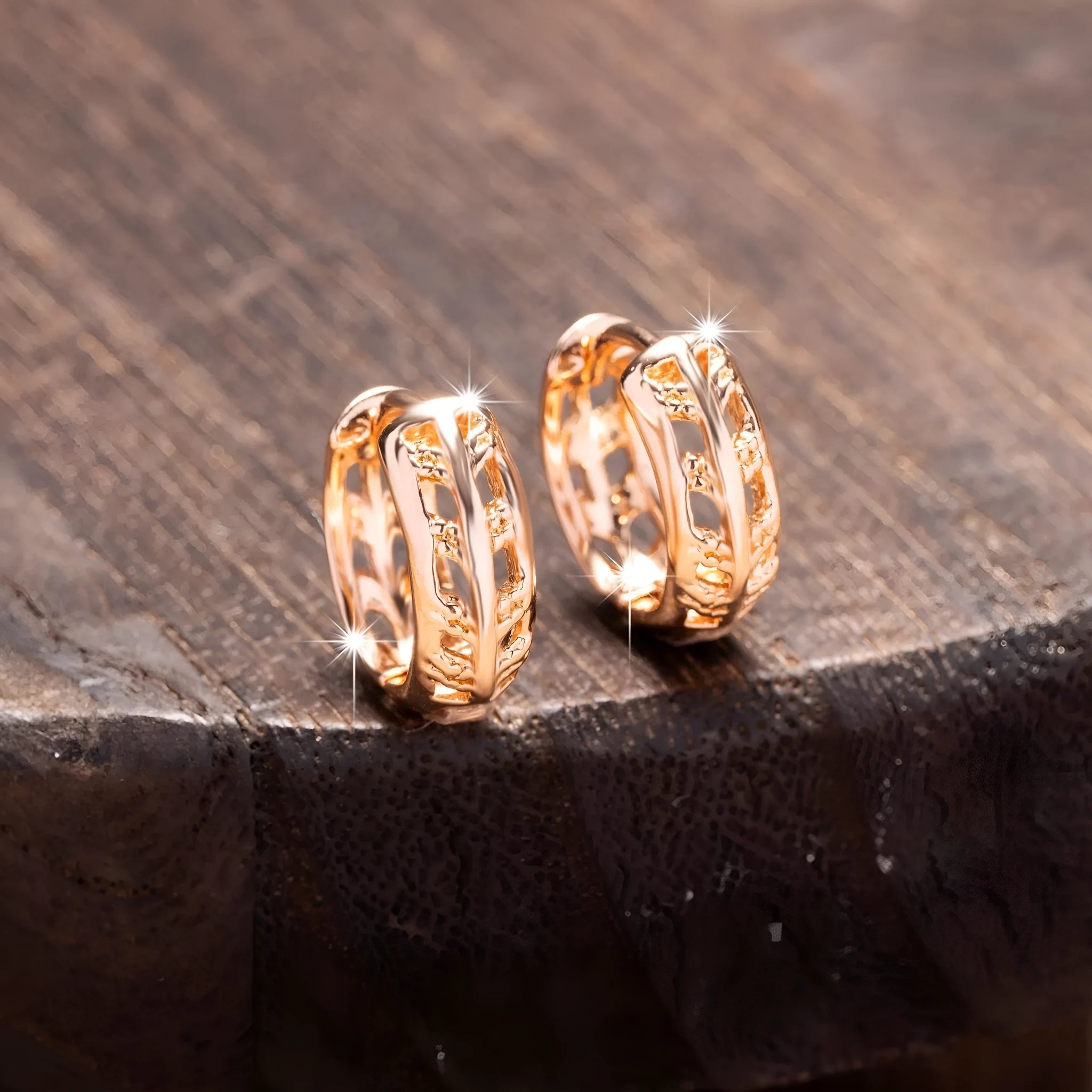Hollowed-out copper earrings in heart and leaf shapes with a rose gold finish.