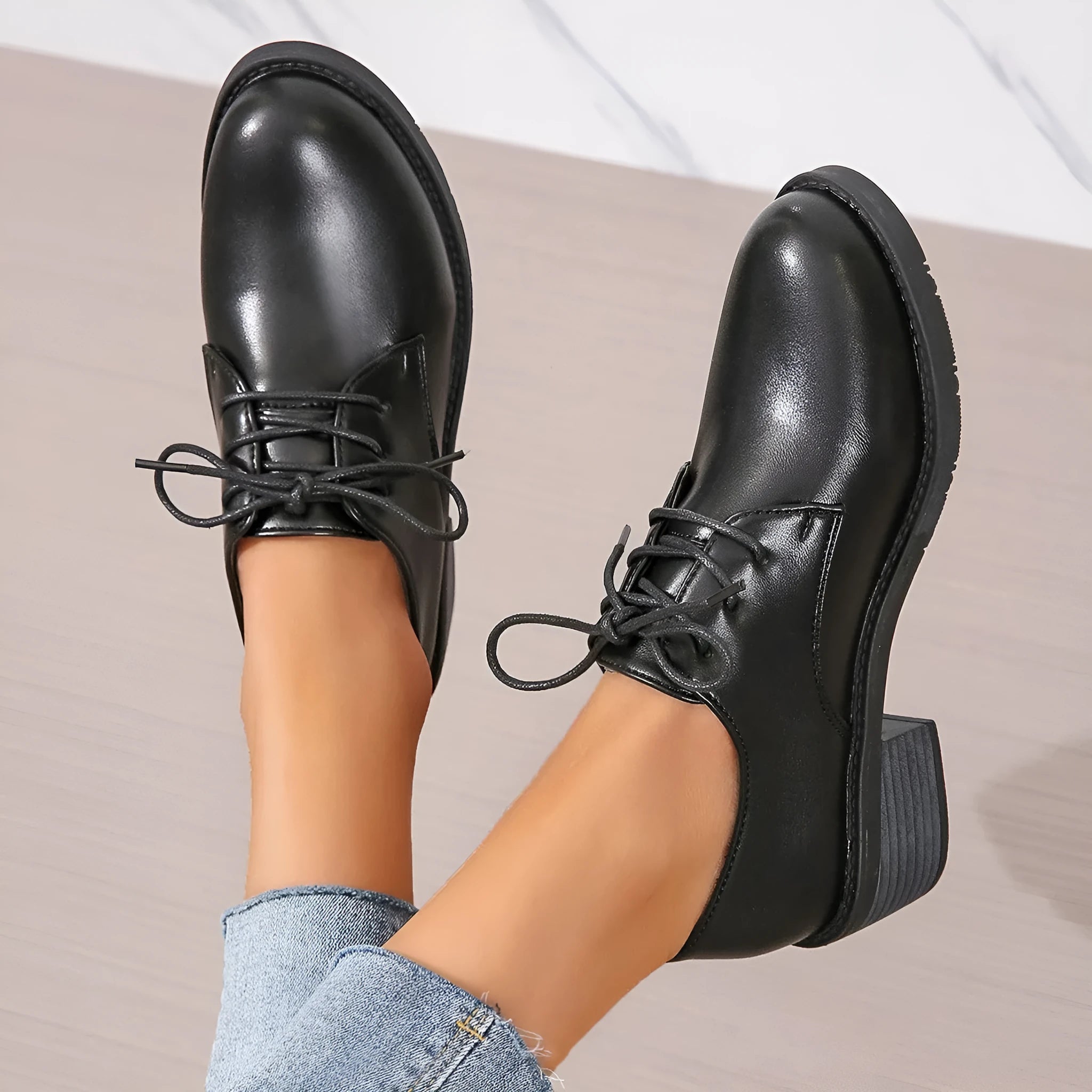 Black women's low top work shoes with a short chunky heel and pointed toe.