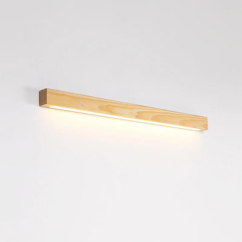 Walnut colour wood and acrylic strip wall lamp in three lengths on a white wall.