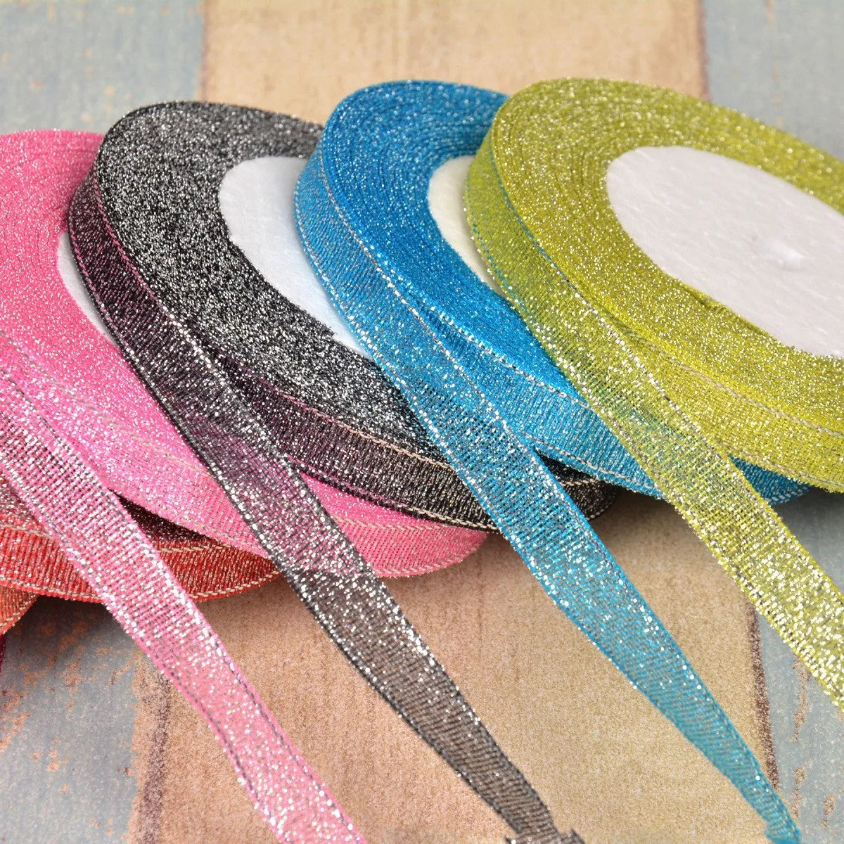 A roll of colourful green onion pattern polyester ribbon with metallic wire highlights, shown at 3-points width.