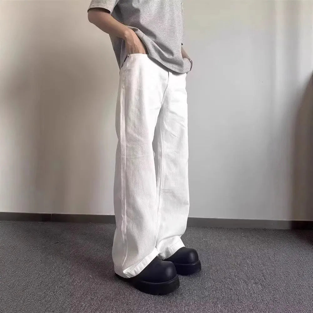 Men's white straight-leg denim jeans with wide leg opening and zip fly