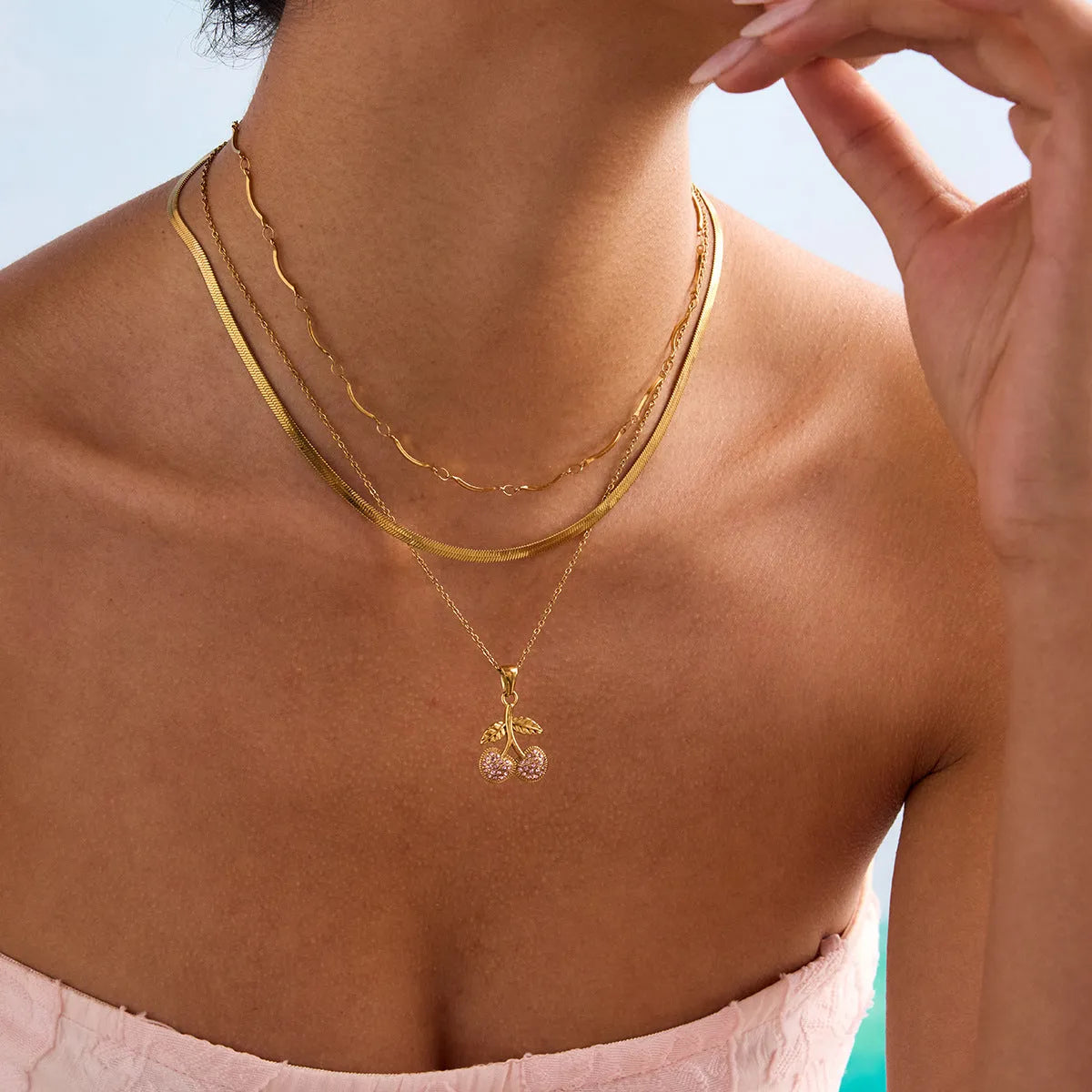 Titanium steel geometric pendant necklace with 18K gold-tone stainless steel blade chain on woman neck