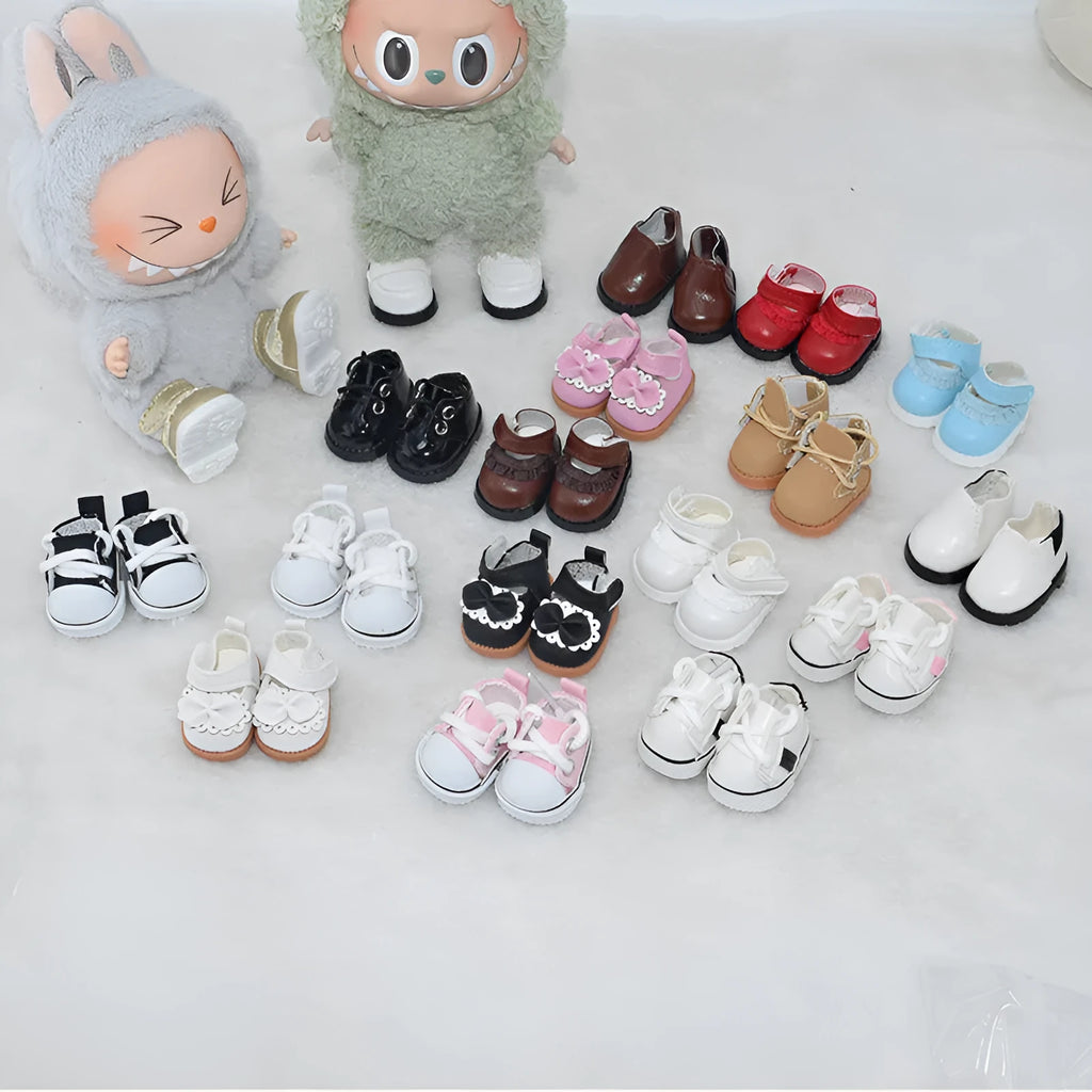 A pair of miniature replacement shoes for a 17cm doll, shown in a selected colour and style such as black boots or pink high heels.