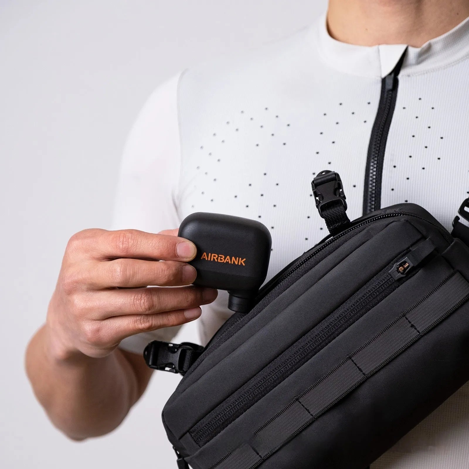 Black AS100 mini electric bike pump with USB charging cable and waterproof bag.