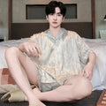 Men's lightweight ice silk pyjama set in a blue houndstooth satin jacquard pattern, showing cardigan top and shorts.