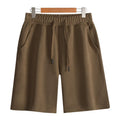 Men's and women's straight cut cotton sports shorts in multiple colours on a plain background.