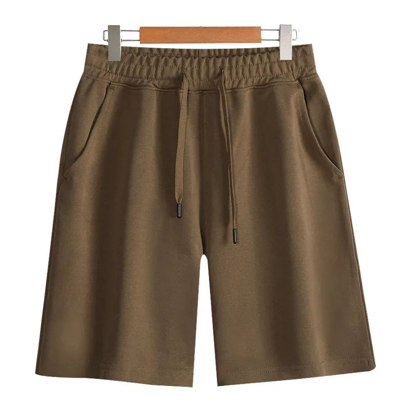 Men's and women's straight cut cotton sports shorts in multiple colours on a plain background.