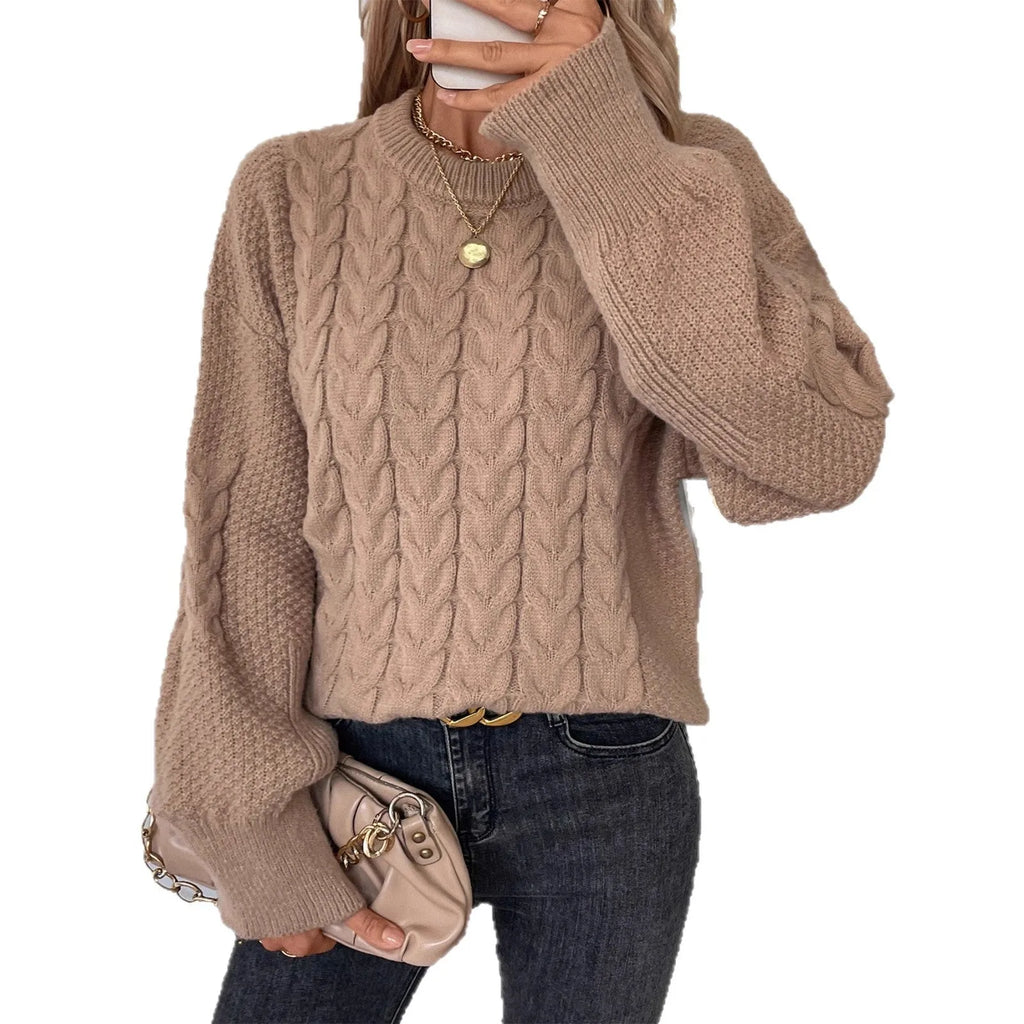 Beige women's loose round neck sweater with a twist design detail on the front.