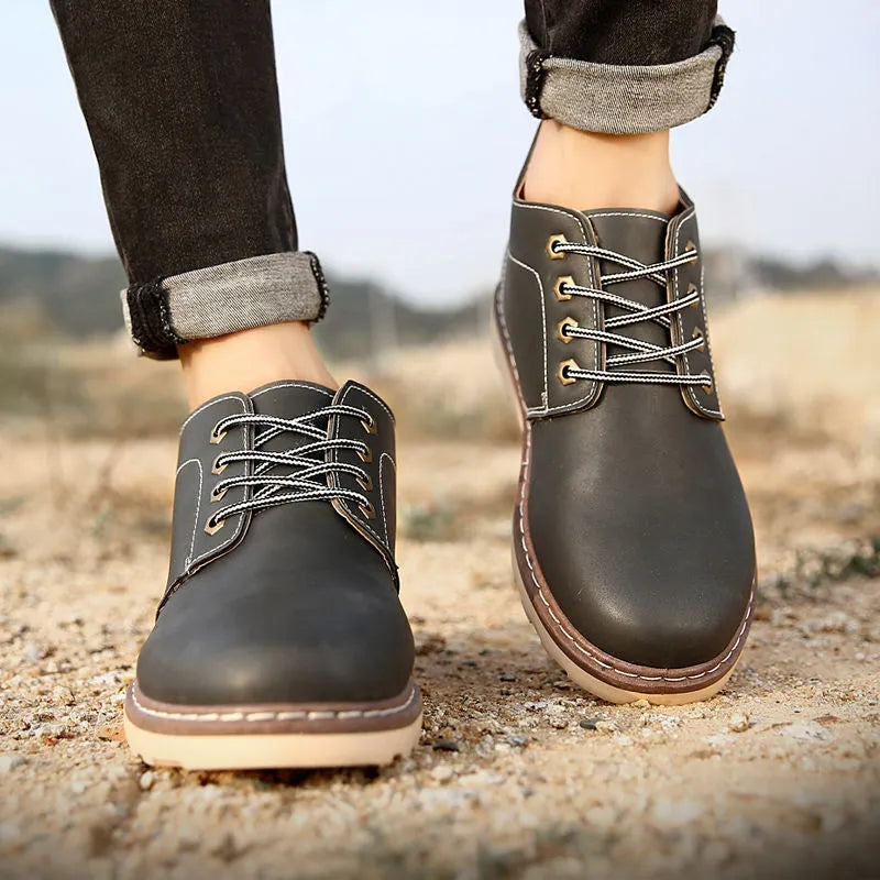 Men's black mid-top Martin boots with flat rubber sole and waterproof construction