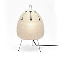 Japanese style table lamp with handmade paper shade and aluminium base on a wooden surface.