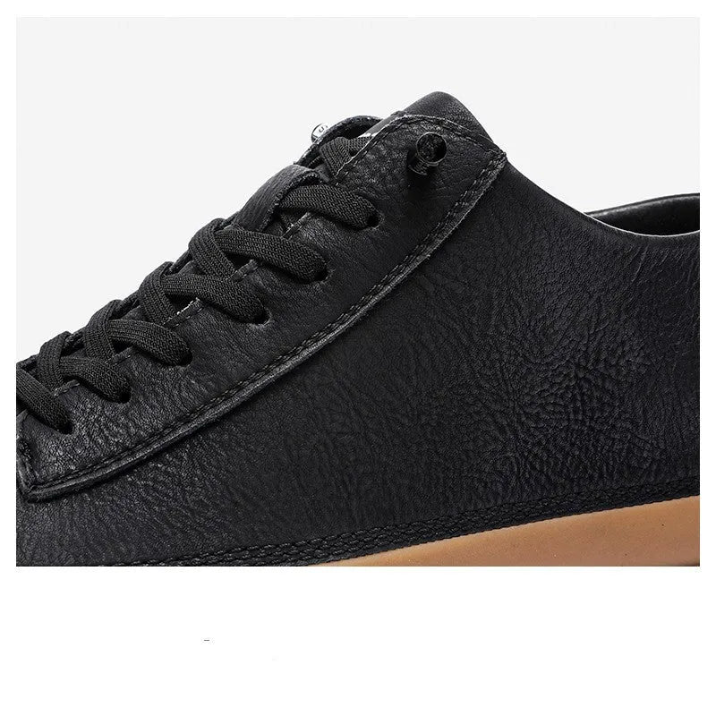 Men's black casual leather shoes with round toe, flat heel, and lace closure on a white background