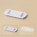 High capacity blue ice cube tray with ice grid and attached storage for the included shovel.