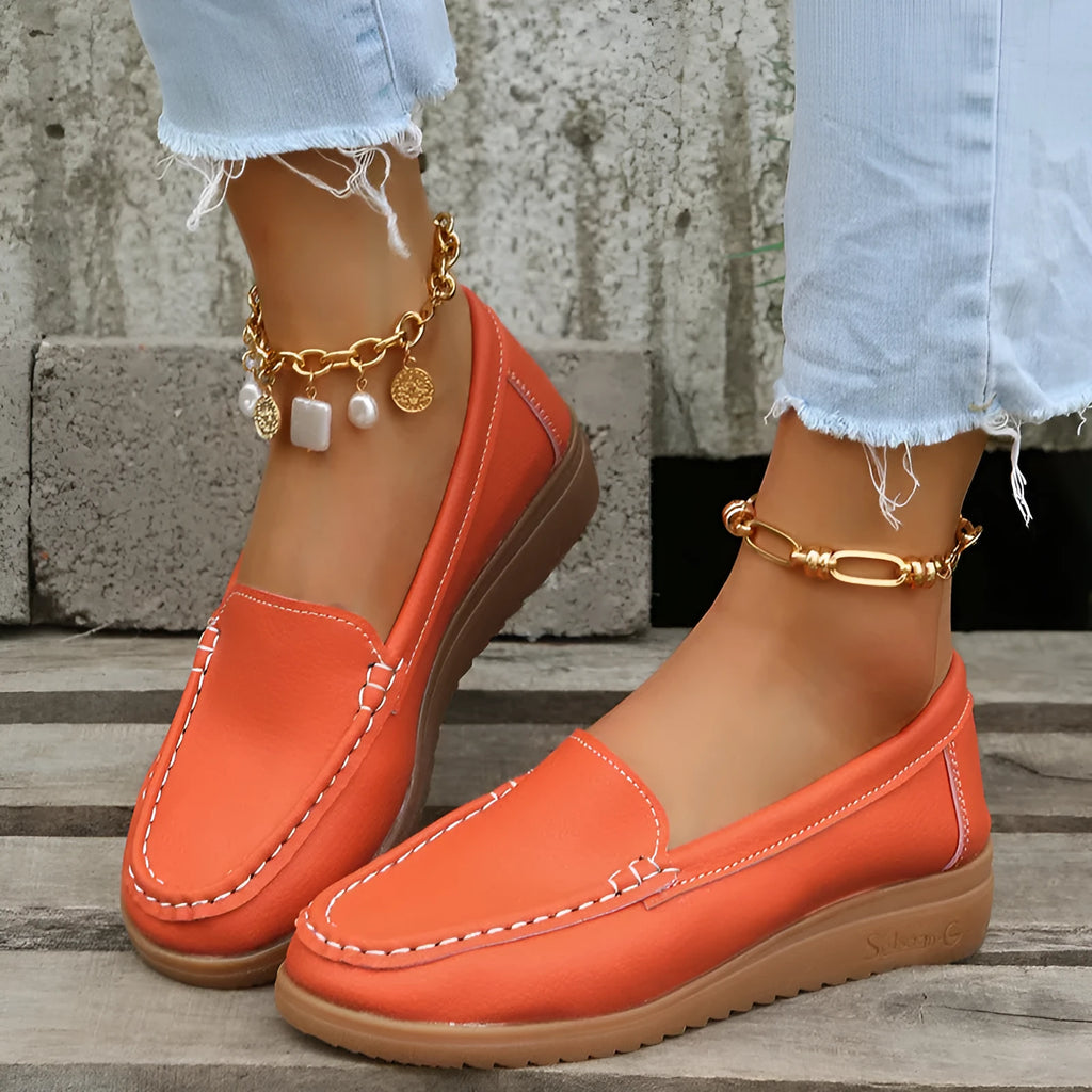 Women's flat loafer shoe in PU leather with a rubber sole, shown in a choice of colours.