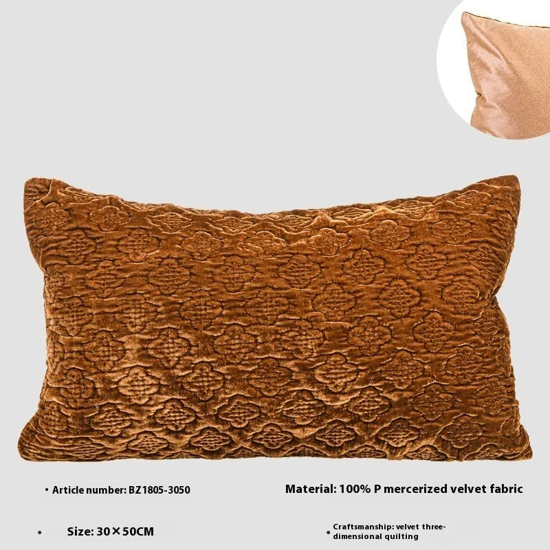 Brown gold antique-style quilted square cushion pillow and matching lumbar pillow on a sofa.