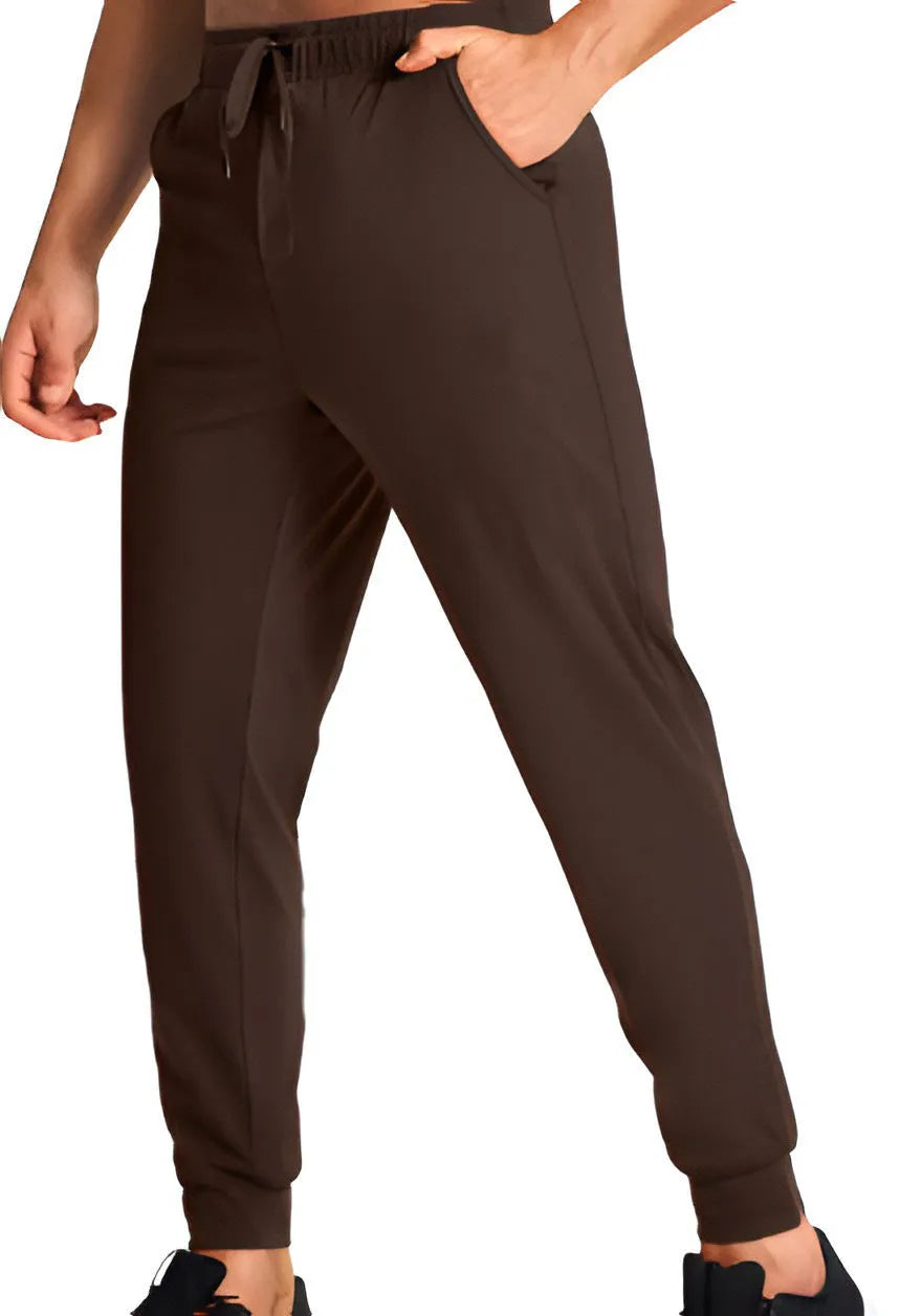 Man wearing loose-fit solid colour casual polyester trousers in a leisure setting.