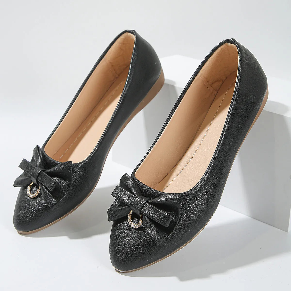 Women's beige flat casual slip-on loafers with a bow knot and shallow mouth design.