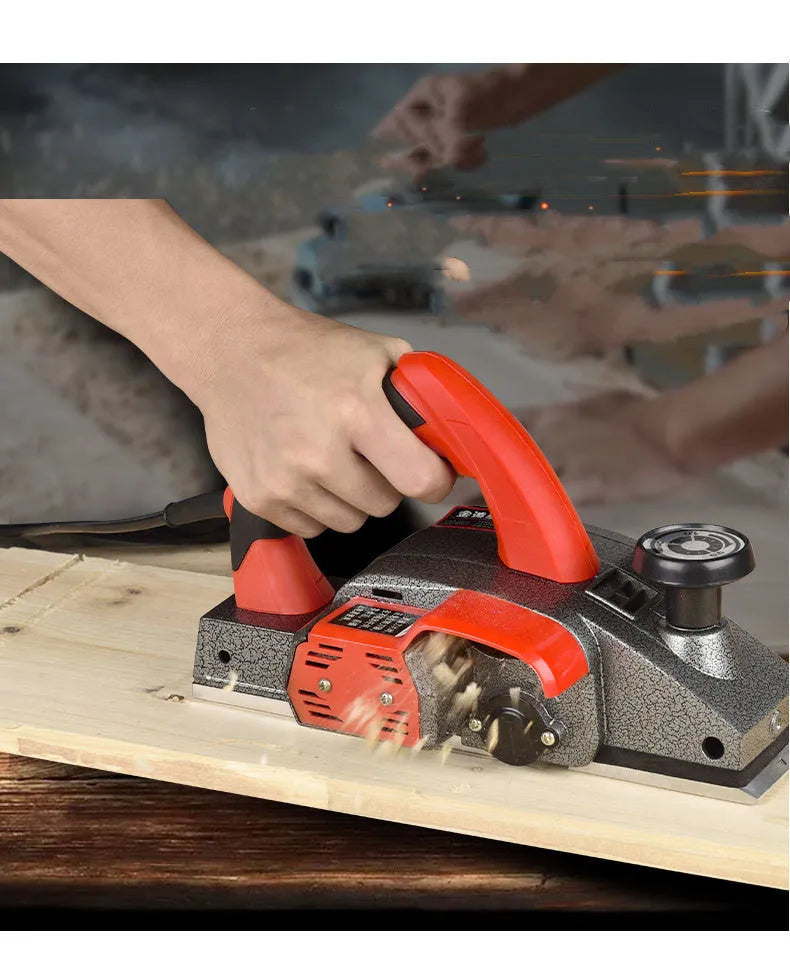 Red aluminium shell electric wood planer with 82mm cutting width on workbench