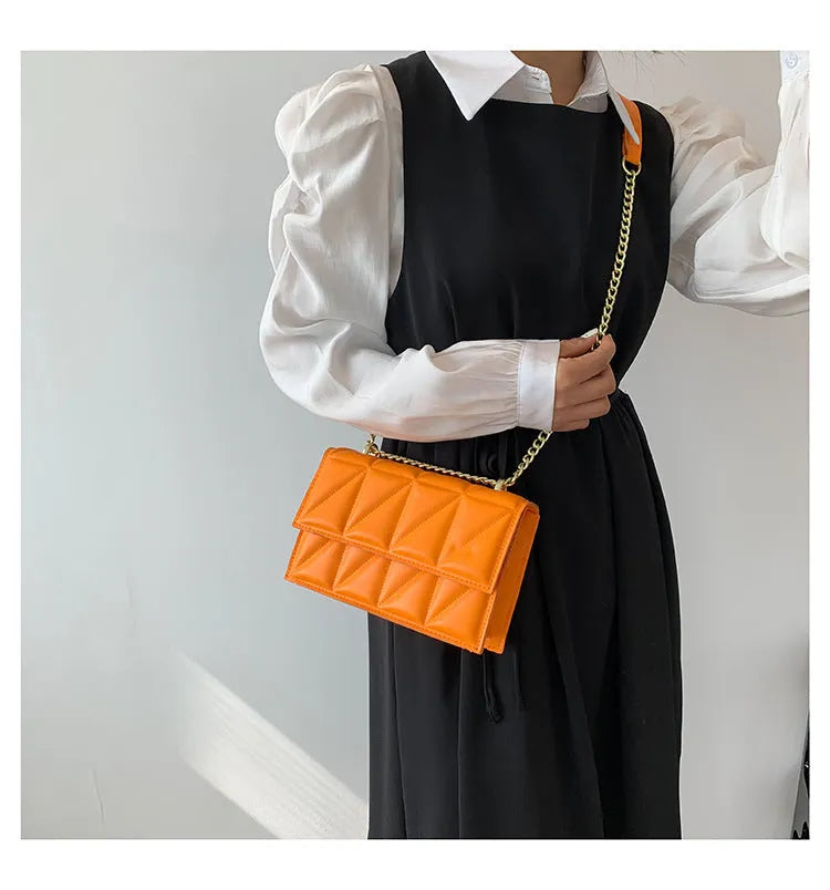 Small square PU chain crossbody bag in horizontal shape with spliced detail, available in five colours.