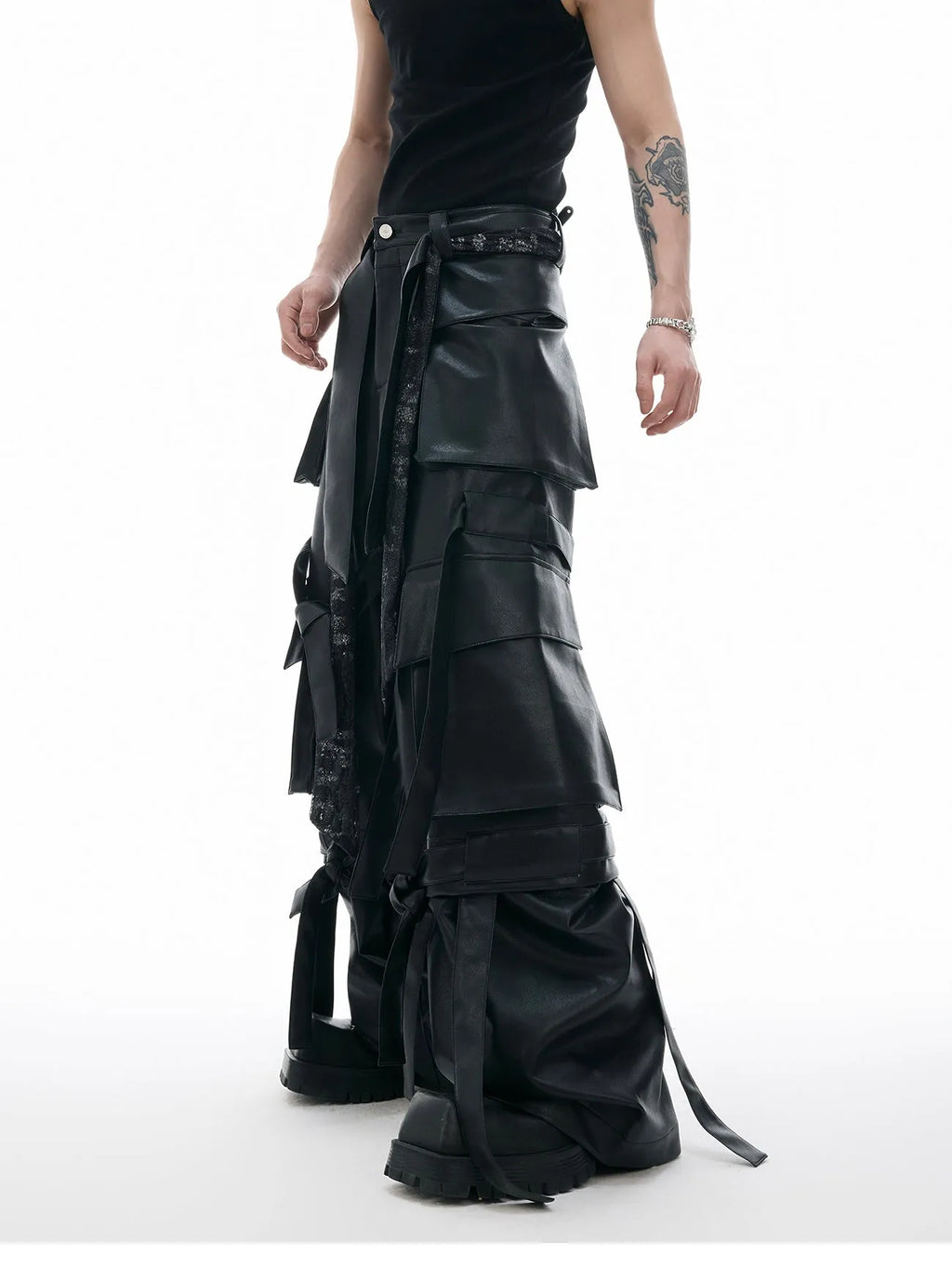 Black retro-style loose-fit trousers with multiple pockets, heavy stitching, and ribbon detail on a hanger.