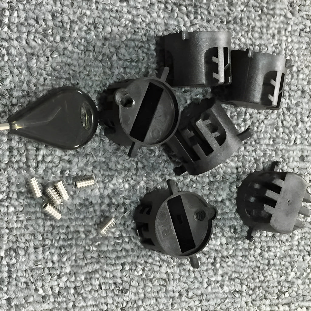 Set of six PVC surfboard G5 tail rudders in round cup design, black colour, on a flat surface