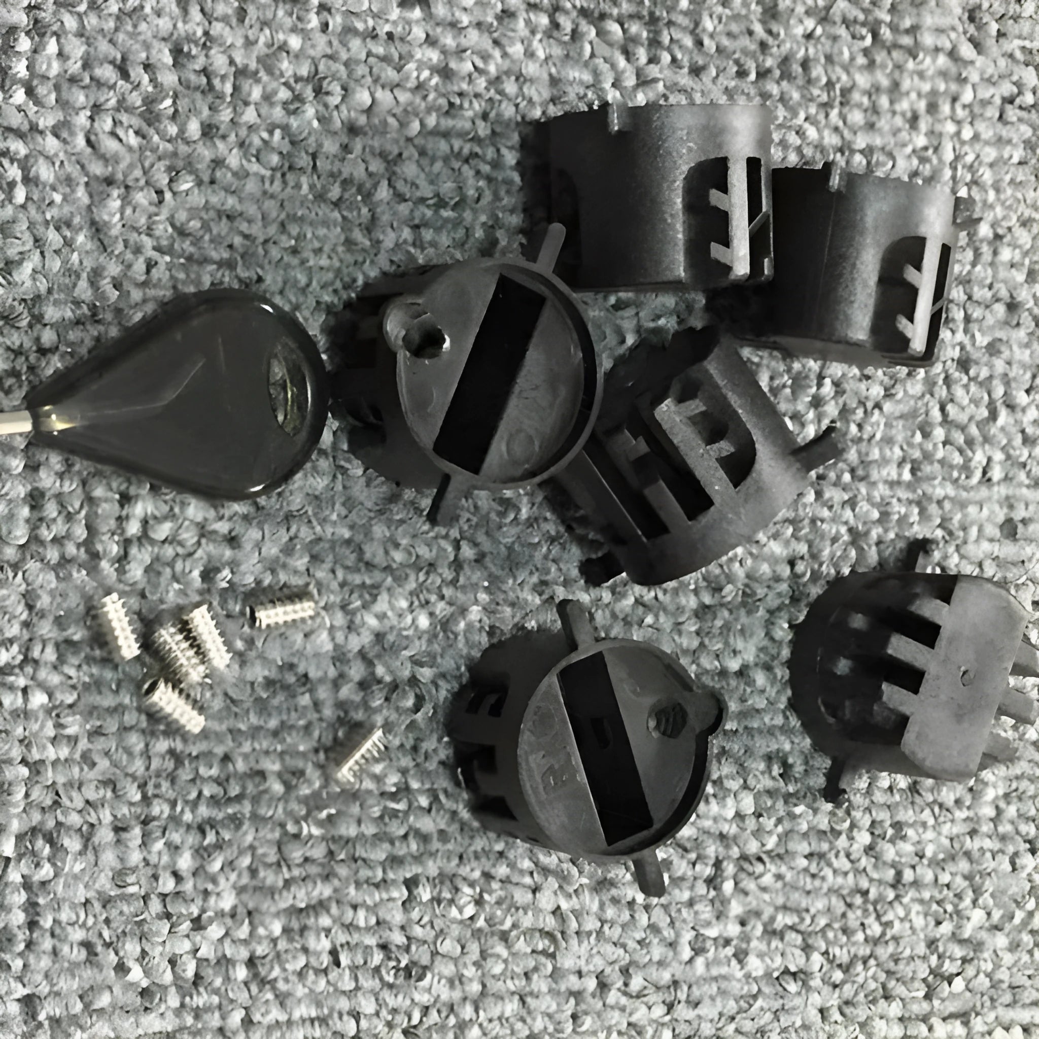 Set of six PVC surfboard G5 tail rudders in round cup design, black colour, on a flat surface