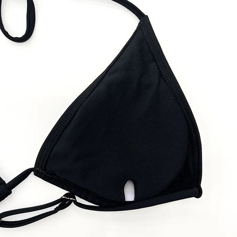Black mesh four-piece bikini set for women with long sleeves and briefs, laid flat.