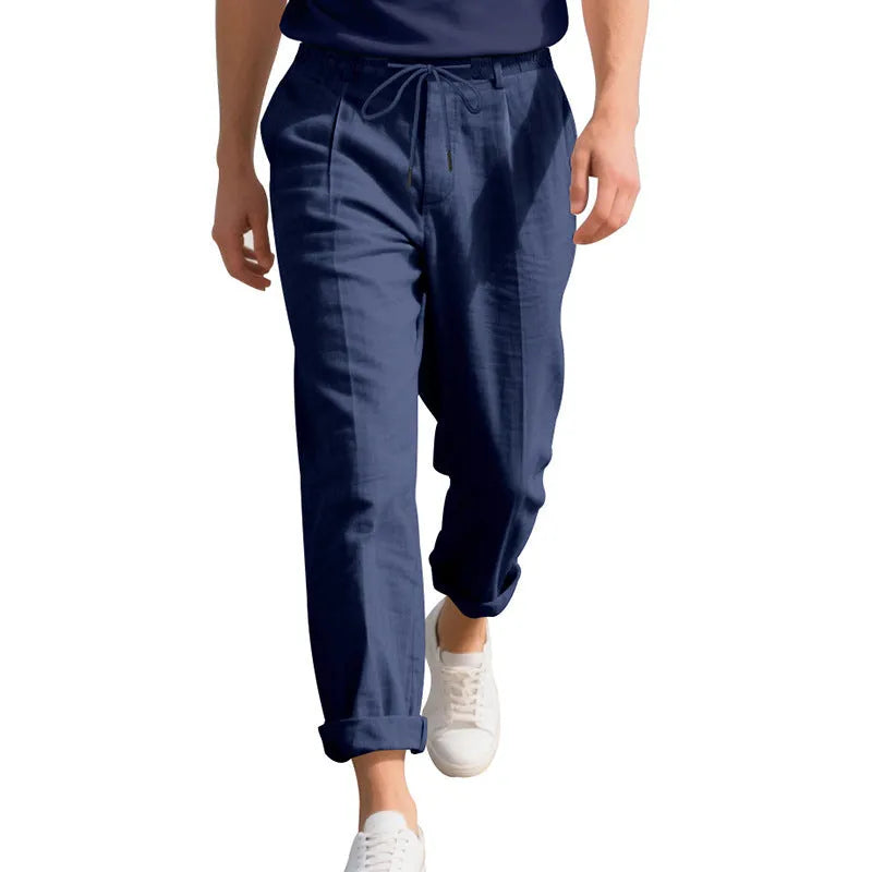 Men's light khaki linen casual trousers with a drawstring waistband and straight-leg silhouette.