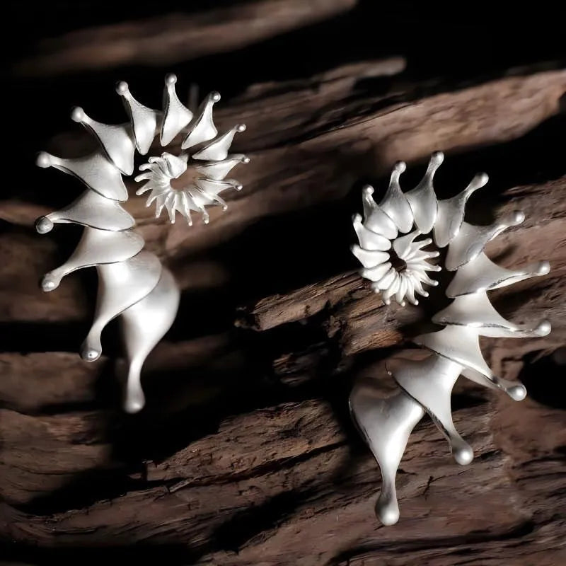 Conch coloured stud earrings with three-dimensional irregular design and matte alloy finish